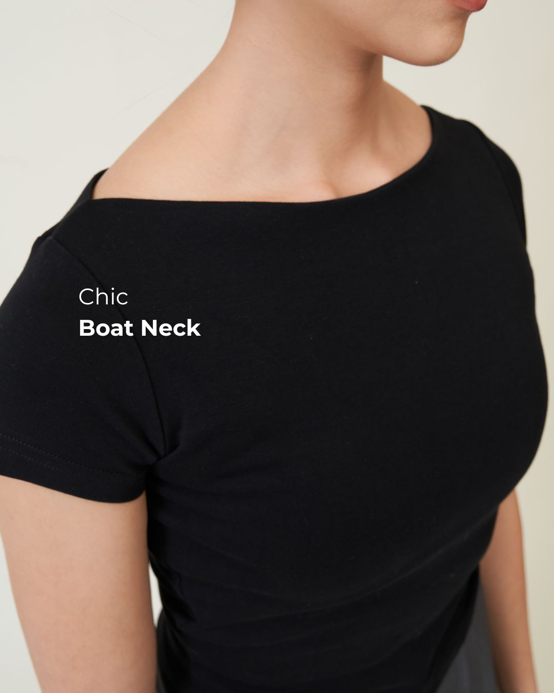 Close-up of the boat neckline and short sleeve on the black Padded Chic Baby Tee