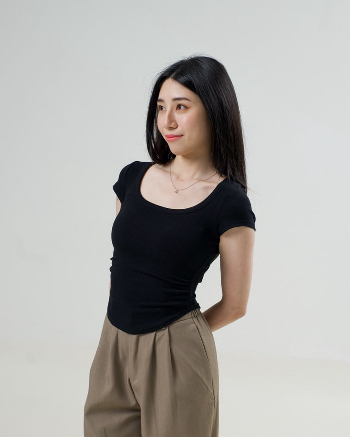 Sculpted Scoop Neck T in Black, showing the short sleeves and side pleats